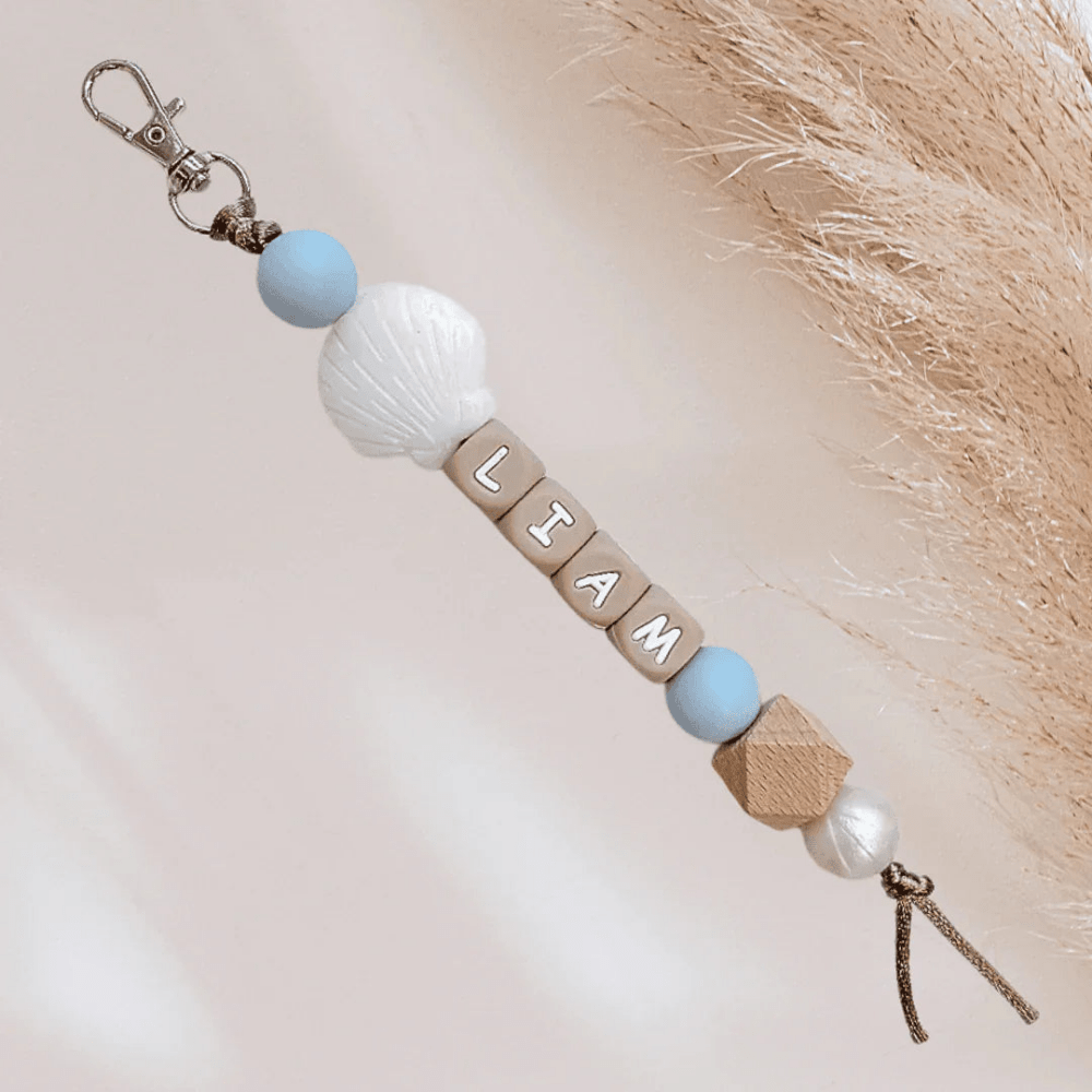 Blue keychain with shell and name